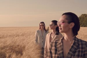 Group of people enjoying wine together at a table representing profitable group dynamics in winery tasting rooms