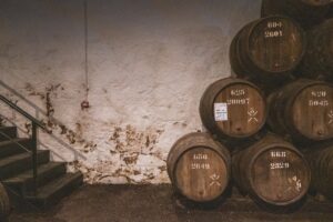 Wine barrels stacked in a cellar representing winery heritage