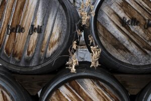 Wine barrels stacked in a cellar representing heritage winery tradition and innovation framework
