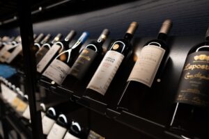 Wine bottles neatly displayed on a shelf representing strategic inventory management