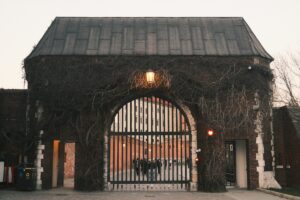 Ancient gate covered in vines representing generational heritage and winery succession planning