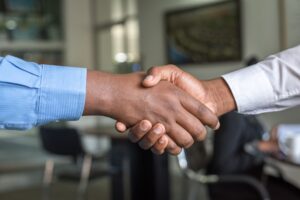 Business handshake representing leadership succession