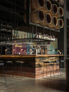 Elegant winery bar counter with wine bottles displayed on wooden shelving