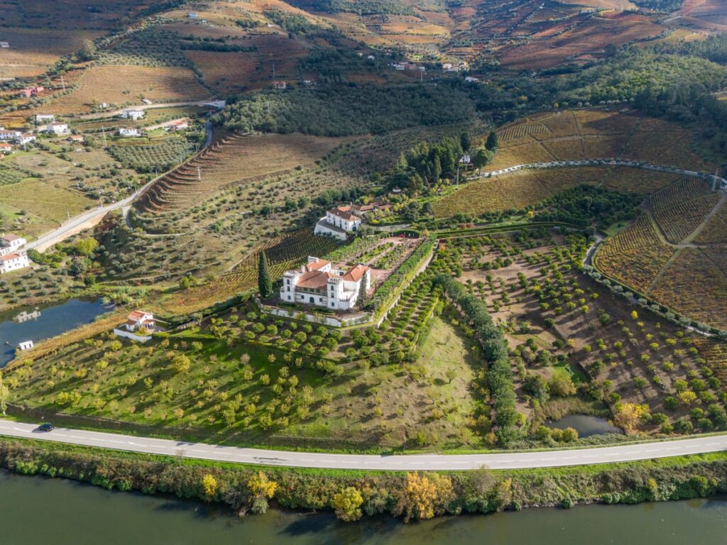Estate surrounded by vineyards and orchards near a river - scenic wine country destination