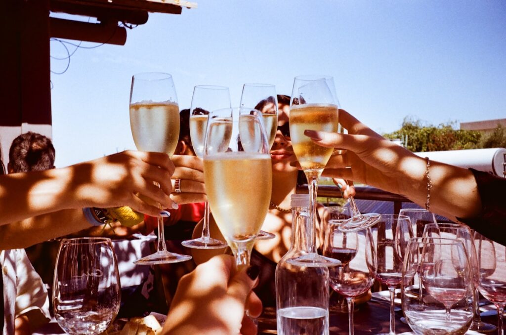 Group toasting with wine glasses celebrating wine club membership advancement