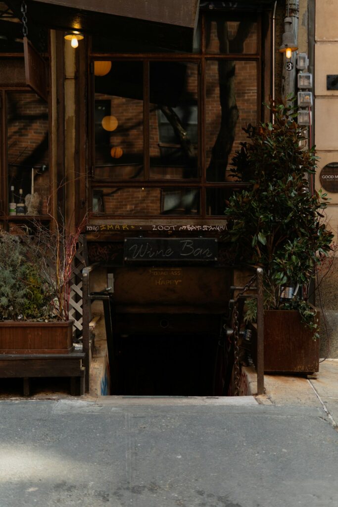 Dark inviting wine bar entrance with consistent atmospheric lighting