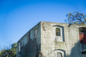 Old historic building with clock on the side weathered facade