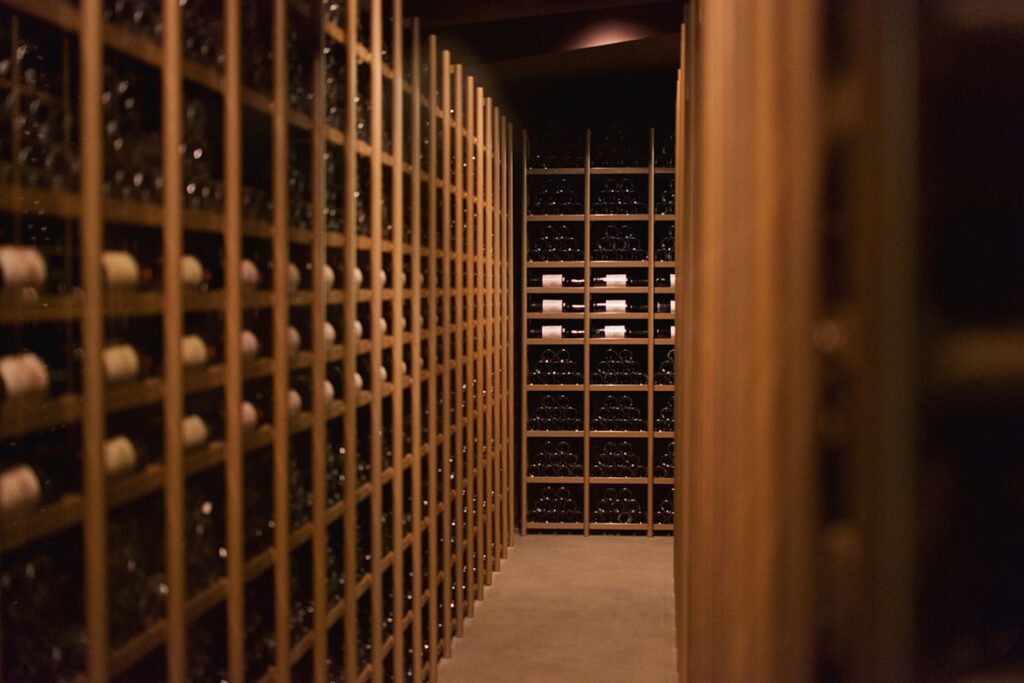 Winemaker pouring wine for guests in cellar memorable moment