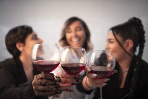 Group of women raising wine glasses celebrating together