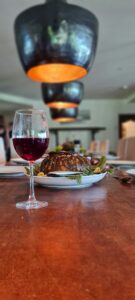 Glass of wine paired with elegant fine dining plate of food