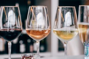 A group of wine glasses arranged on a tasting table for a new wine release