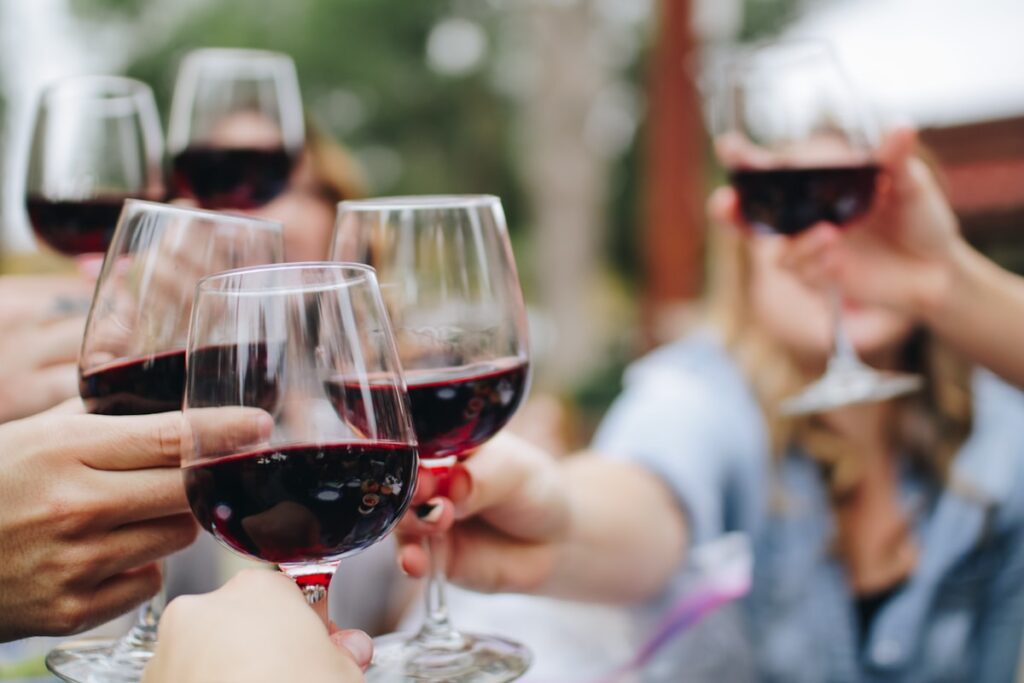 People raising wine glasses in a celebratory toast at a premium wine tasting